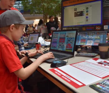 An image of a child playing The Stacks at our stand at Coolest Projects UK