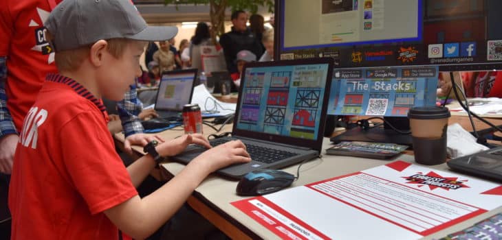 An image of a child playing The Stacks at our stand at Coolest Projects UK